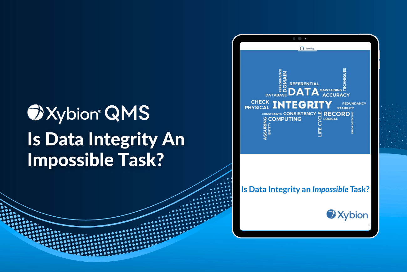 Promotional image for Xybion QMS with the title 'Is Data Integrity an Impossible Task?' featuring a tablet displaying content with a word cloud centered on 'Data Integrity,' set against a blue gradient background.